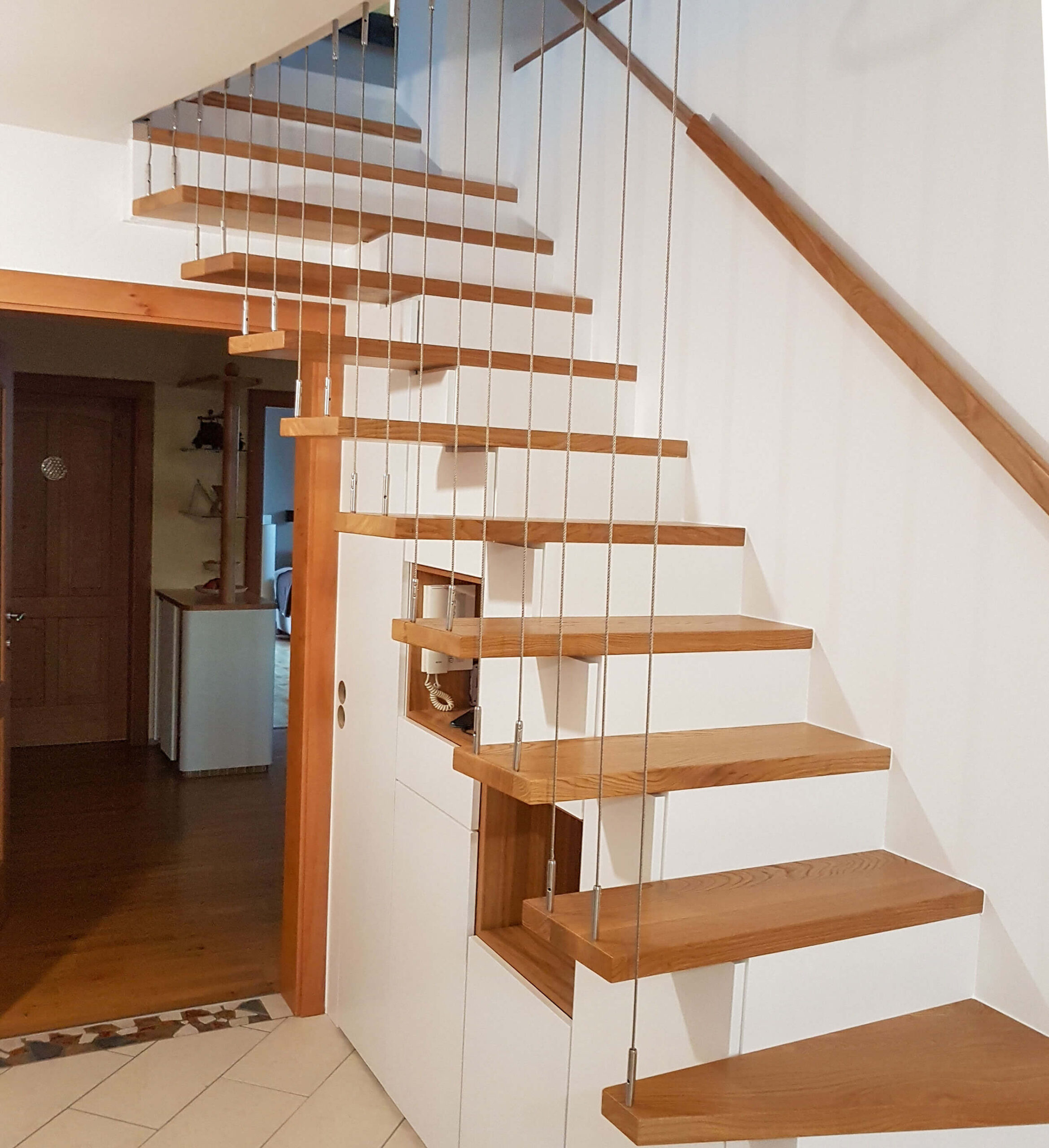 "schwebende" Holztreppe mit Schränken